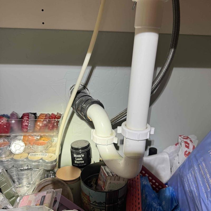 PVC sink drain pipes and fittings under kitchen sink