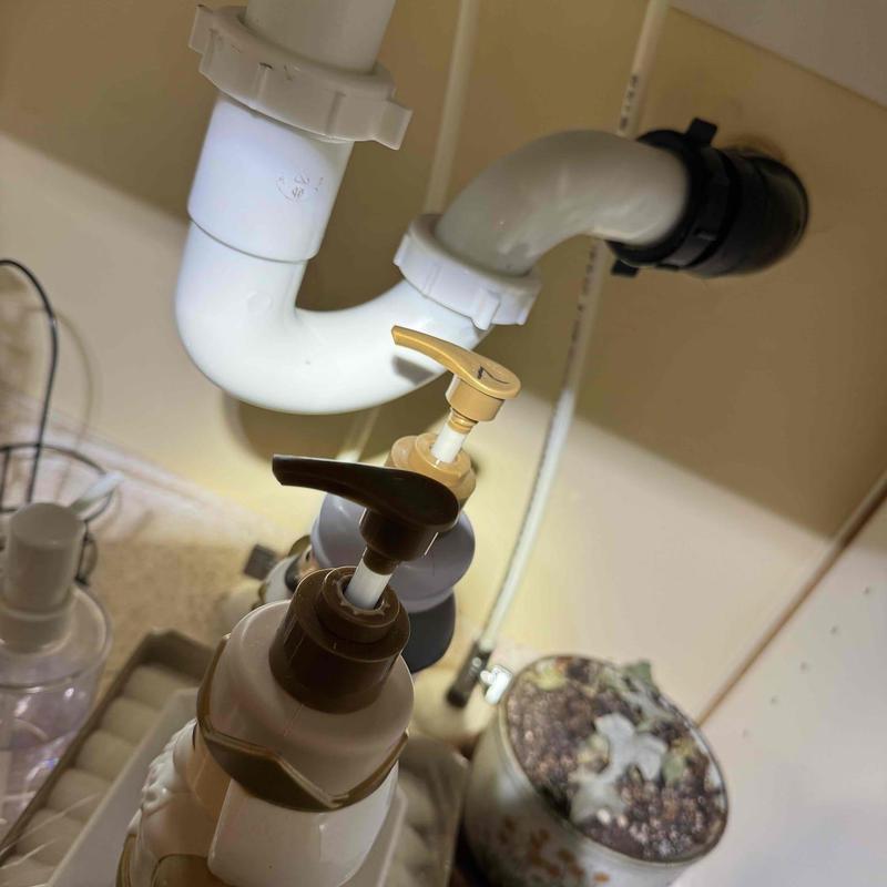 PVC drain pipe under sink with trap assembly