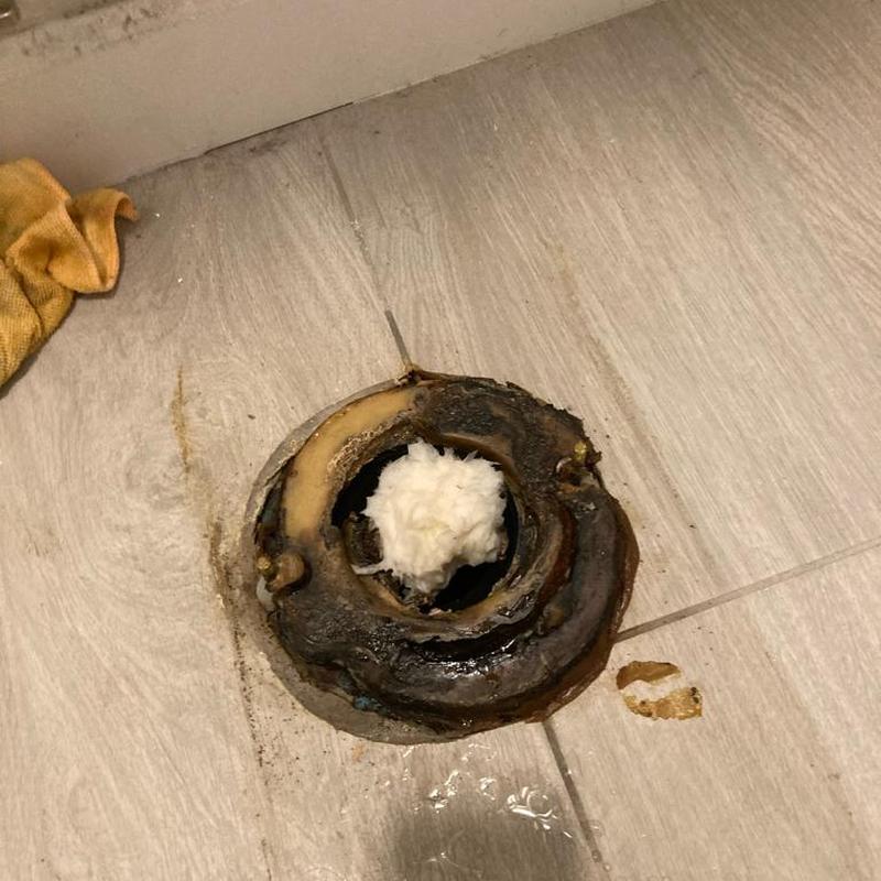 Toilet flange with old wax ring and debris removal Toilet flange with old wax ring and debris removal