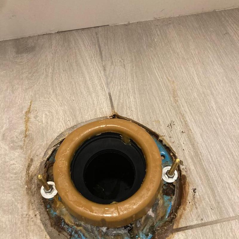 Toilet flange with new wax ring installation in tile floor Toilet flange with new wax ring installation in tile floor