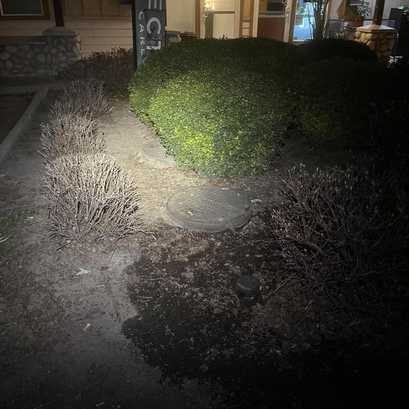 Grease interceptor and cleanout covers at night outdoors Grease interceptor and cleanout covers at night outdoors