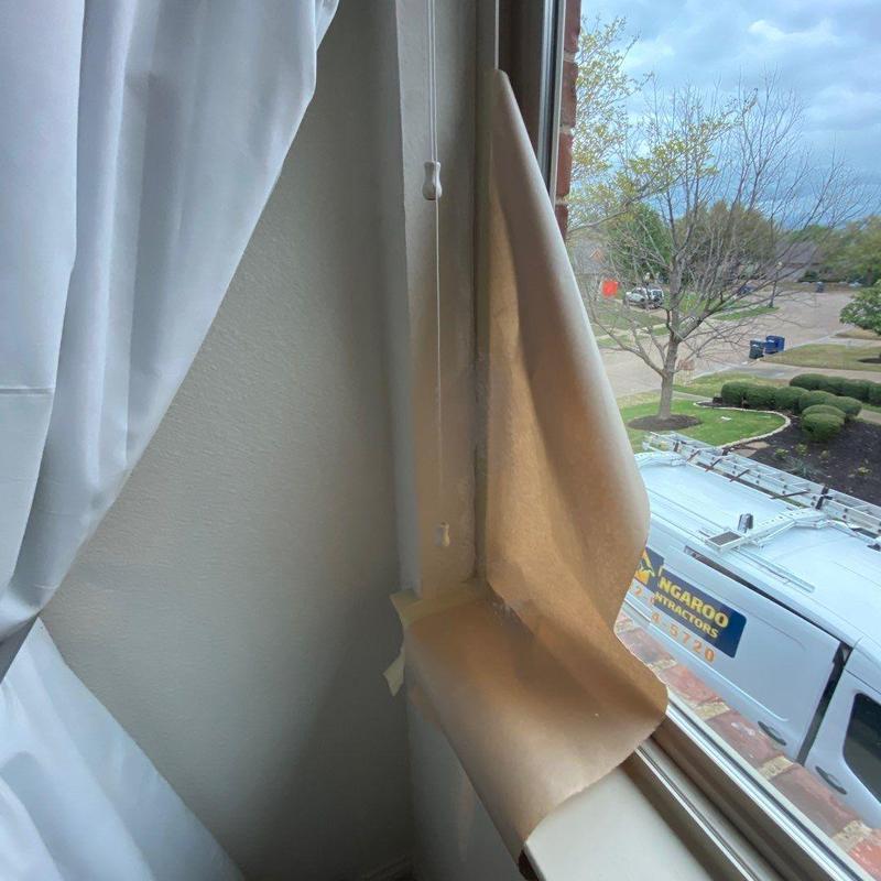 Vinyl window with damaged drywall and trim repairs