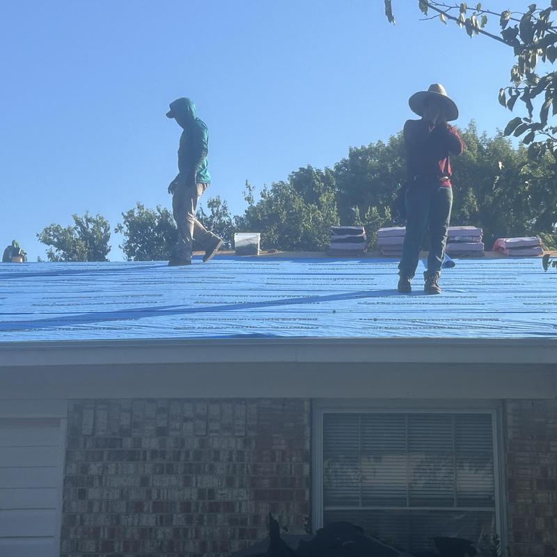 Synthetic foam roofing underlayment installation on house roof