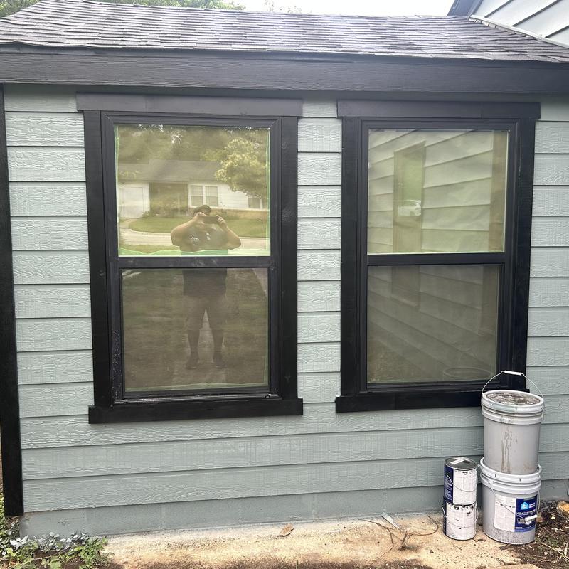 Hardie backer siding with black window trim and paint