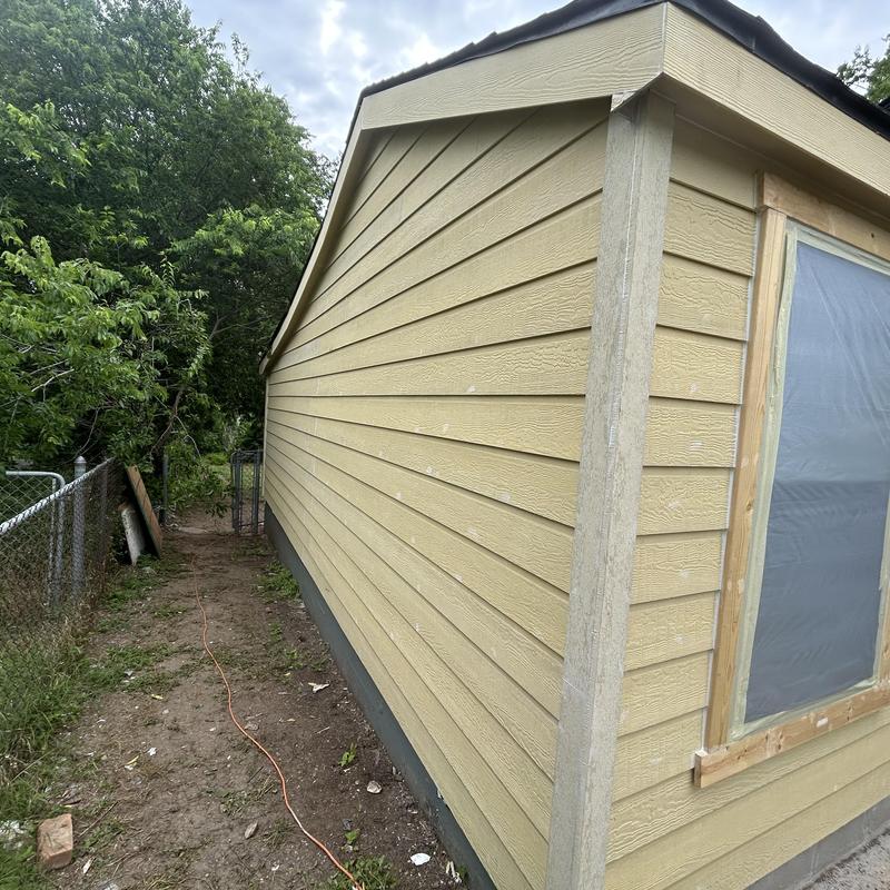 Exterior siding installation on beige house corner