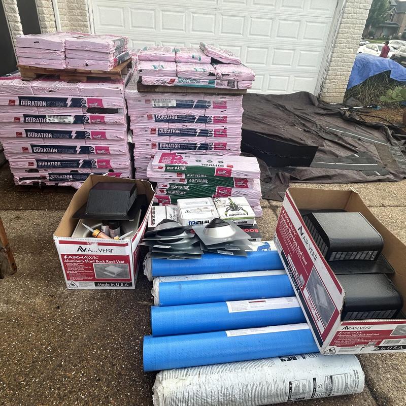 Owens Corning shingles and roof vents staged for install
