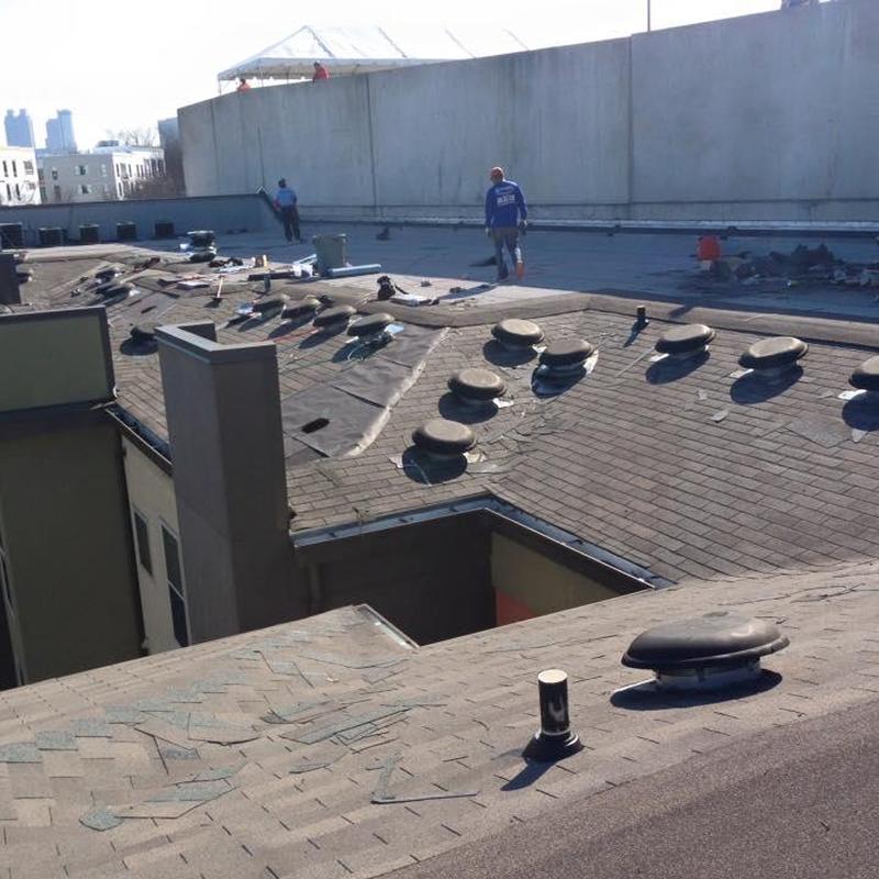 Asphalt shingle roof with vents on apartment building