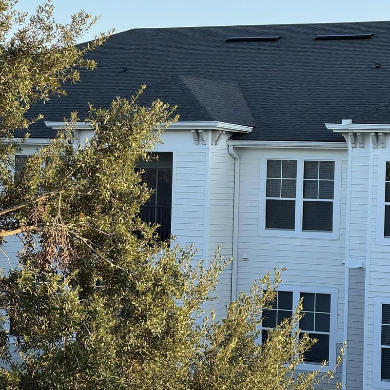 Architectural shingle roof on white apartment building