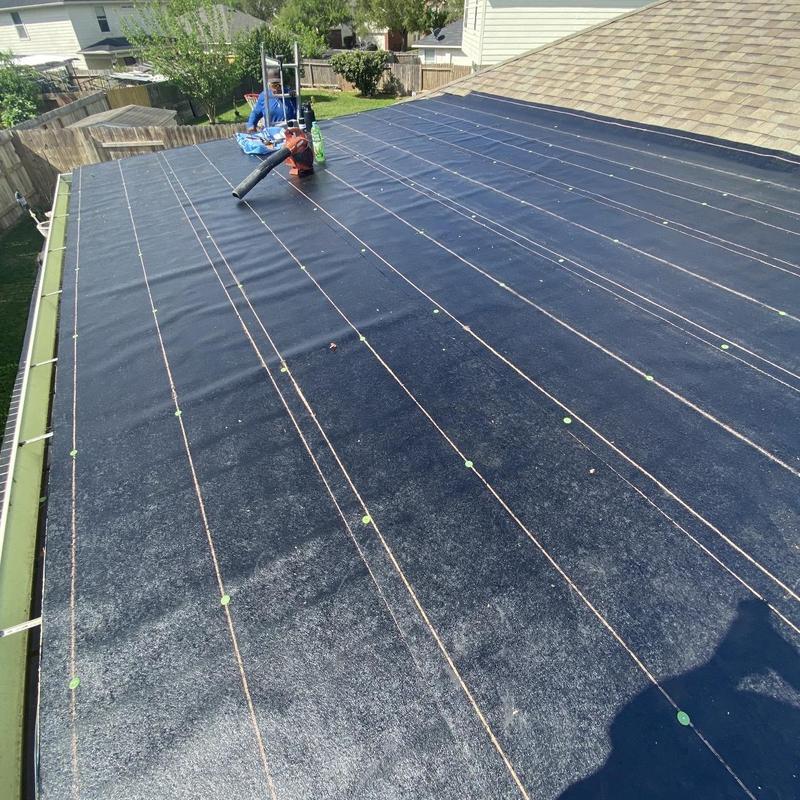 Torch down roll roofing installation on low-slope roof