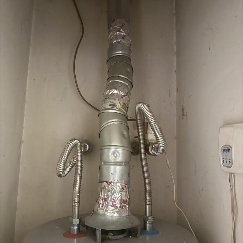 Water heater vent and flexible gas lines in utility closet