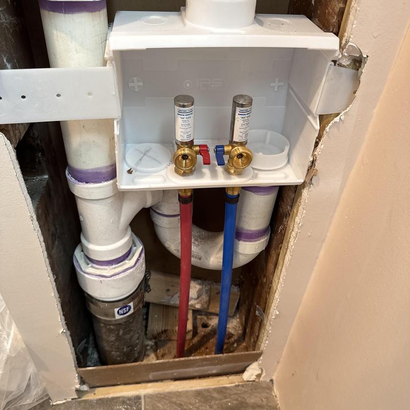 Washing machine box with hot and cold valves installed