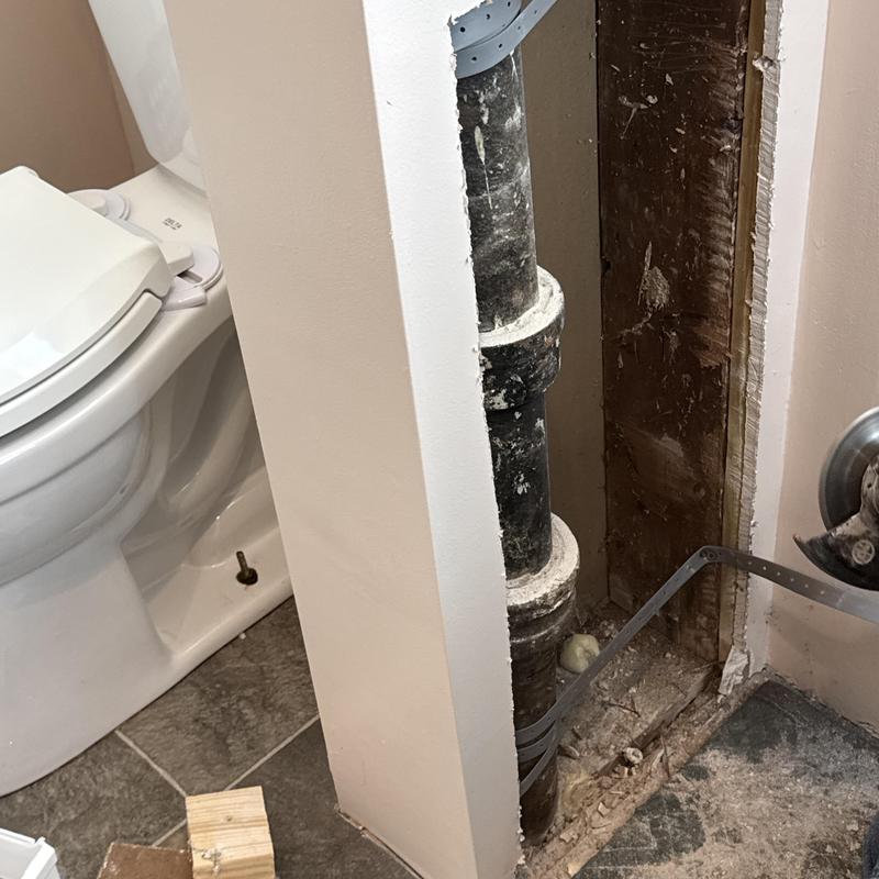 Cast iron soil pipe inside bathroom wall cavity installation