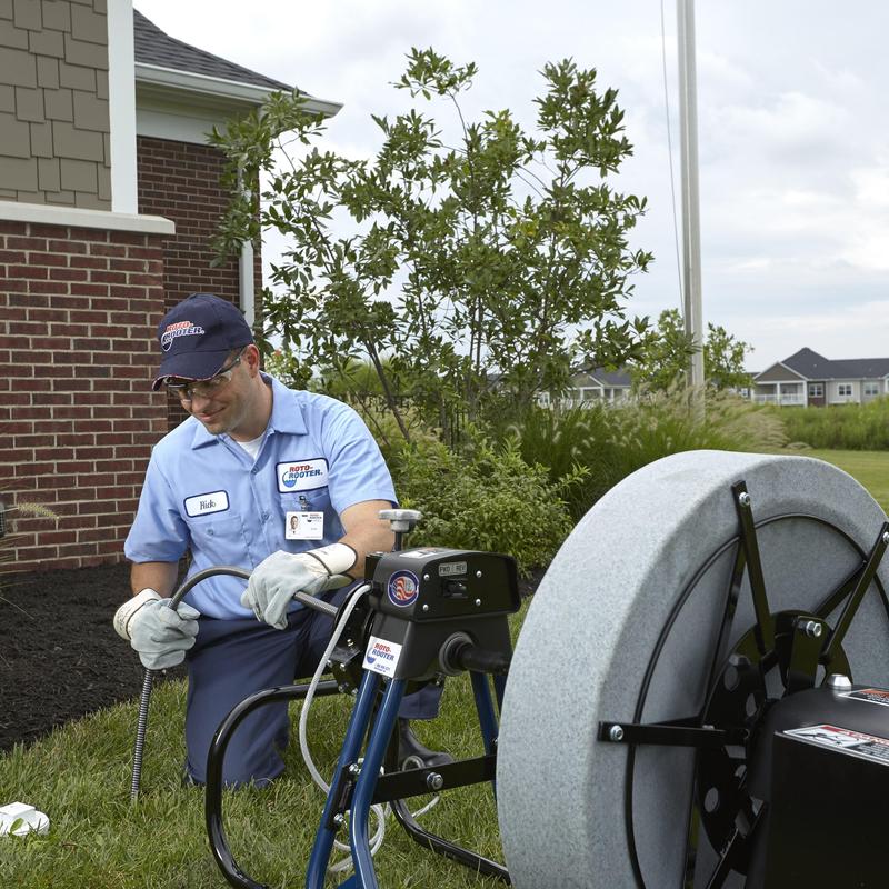 Bathtub drain cleaning machine with plumber outside