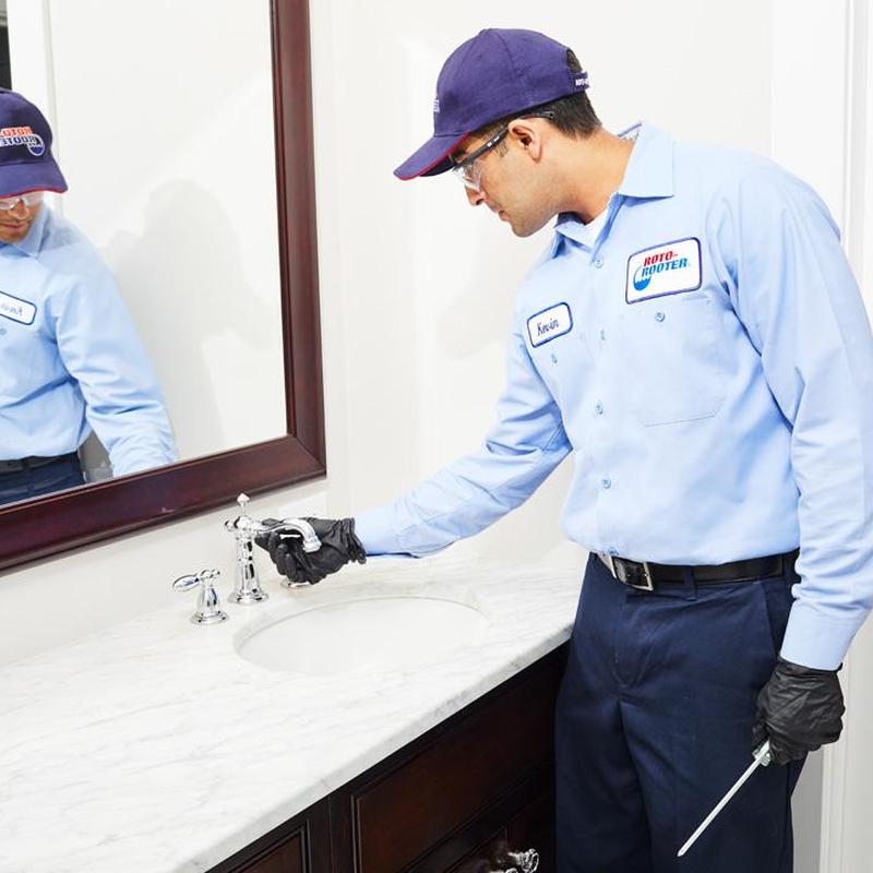 Bathroom sink faucet inspection by plumber technician