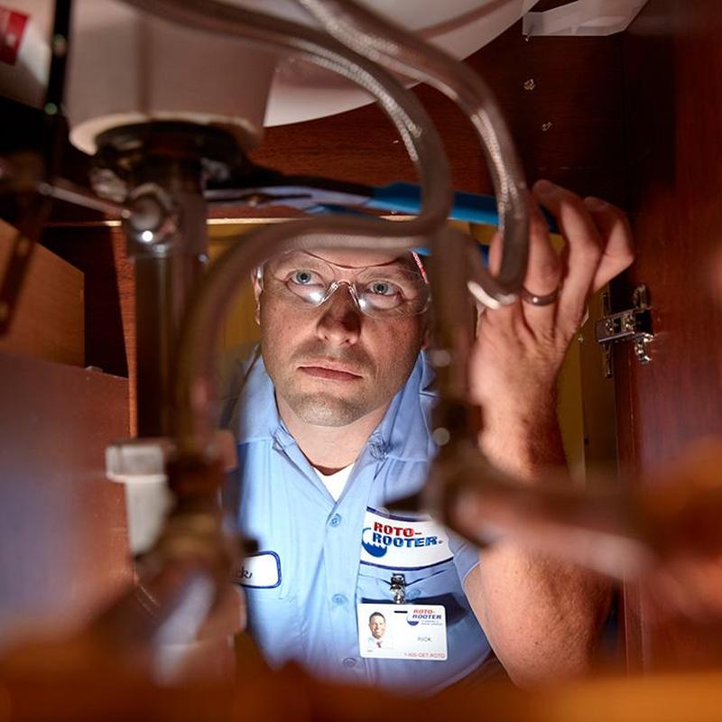 Bathroom sink plumbing inspection under cabinet