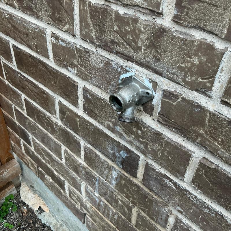 4-inch frost proof hose bib with vacuum breaker on brick wall