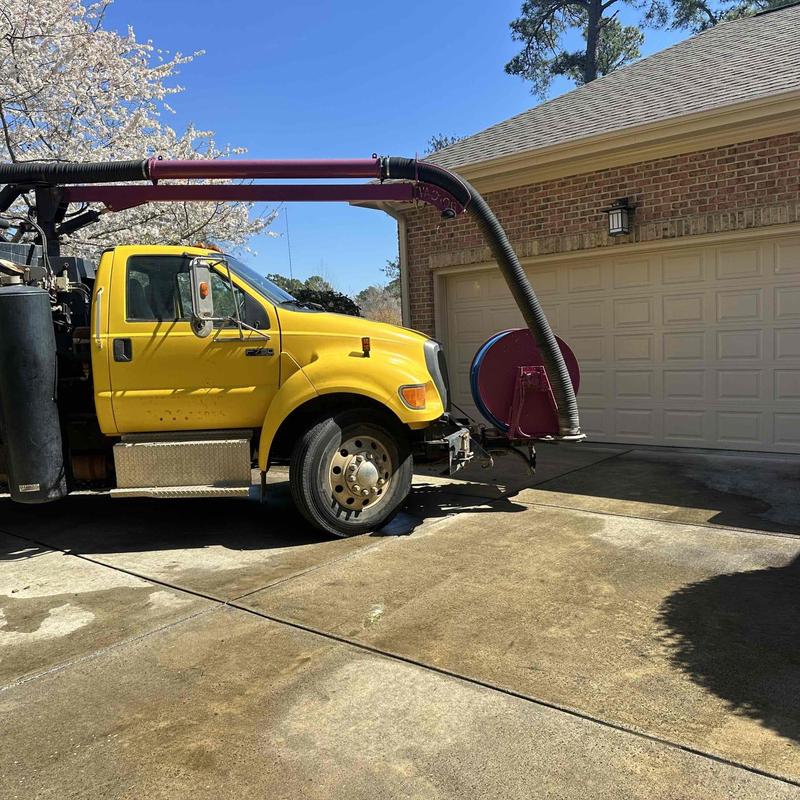 Vacuum truck hose cleaning underground plumbing line