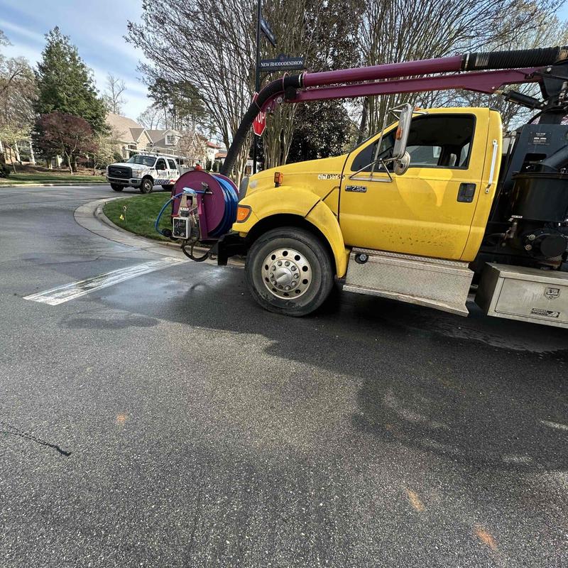 Vacuum truck with hose reel on street curbside