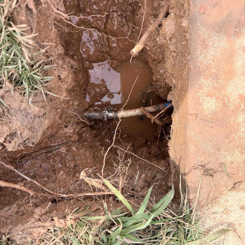 Underground water pipe leak with clamp repair in mud