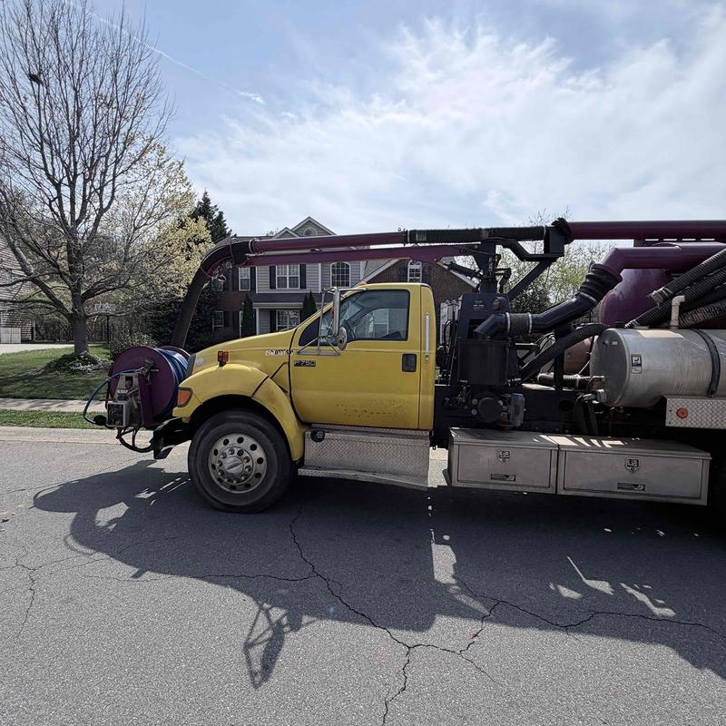 Vacuum truck hose and reel on residential street
