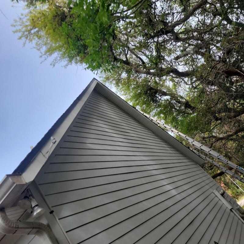 Metal roof trim and siding replacement with ladder