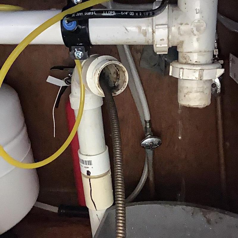 Kitchen sink drain pipe with cleaning snake inside