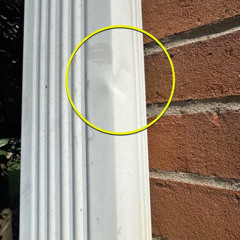 Vinyl gutter dent with yellow damage marker