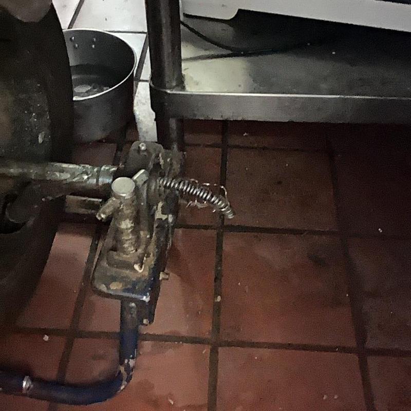 Kitchen sink drain snake clearing clog