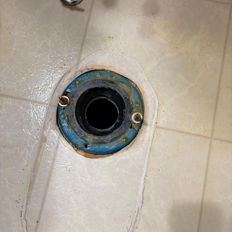 Toilet flange on tiled floor with bolts installed