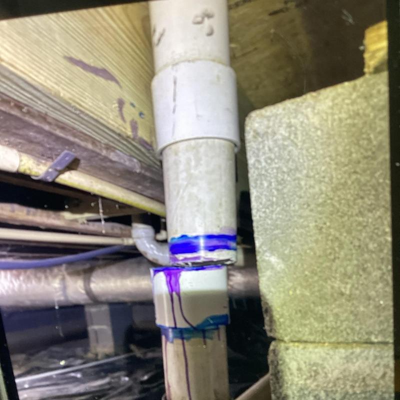 PVC drain pipe with joint purple primer under floor