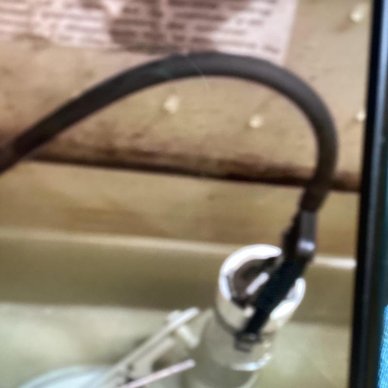 Fluidmaster fill valve with connected hose inside toilet tank