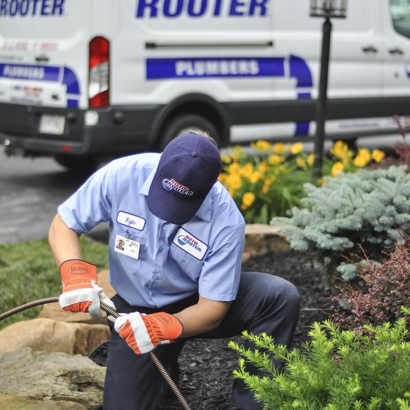 Sewer line cleaning with plumber using drain snake tool