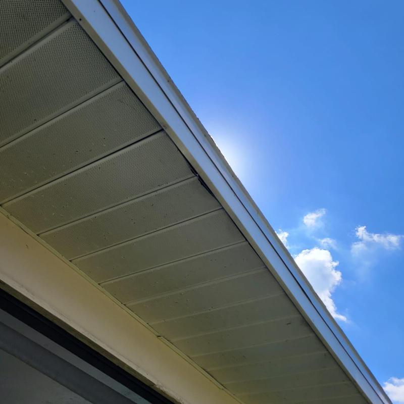 Soffit panels and roof edge under clear sky