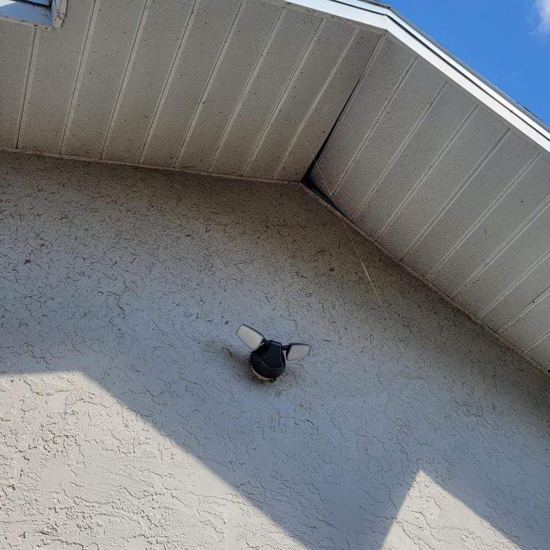 Soffit panels with ventilation gap and exterior wall light