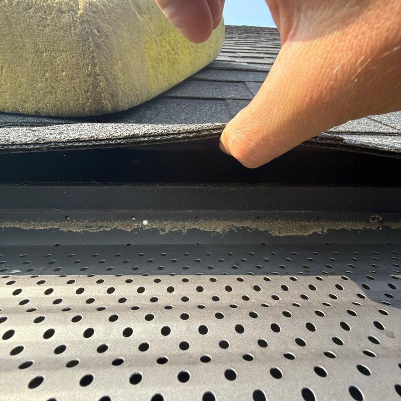 Asphalt shingles lifted to inspect roof flashing condition