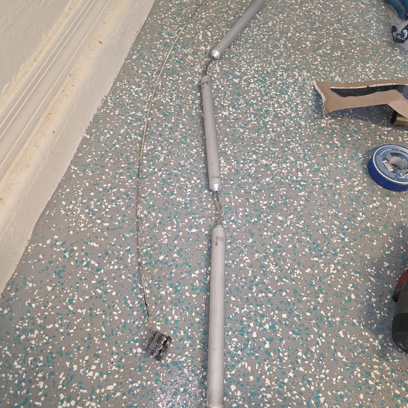 Water heater anode rod removed on speckled floor