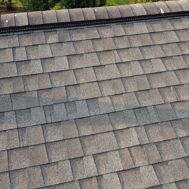 Asphalt shingle roof with visible wear and discoloration