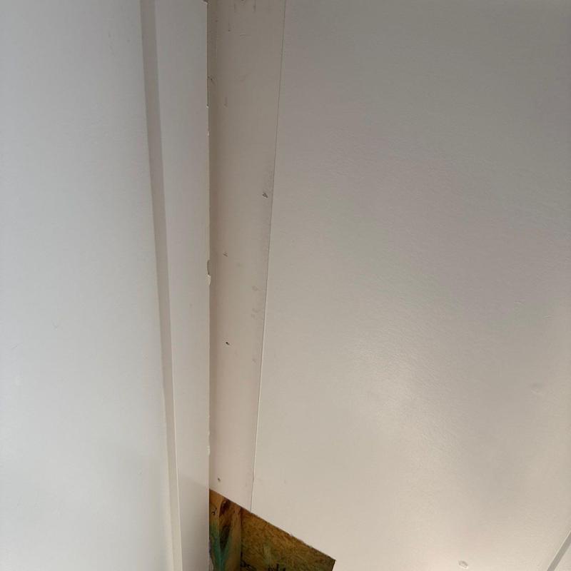Drywall corner with paint touch-up and minor damage