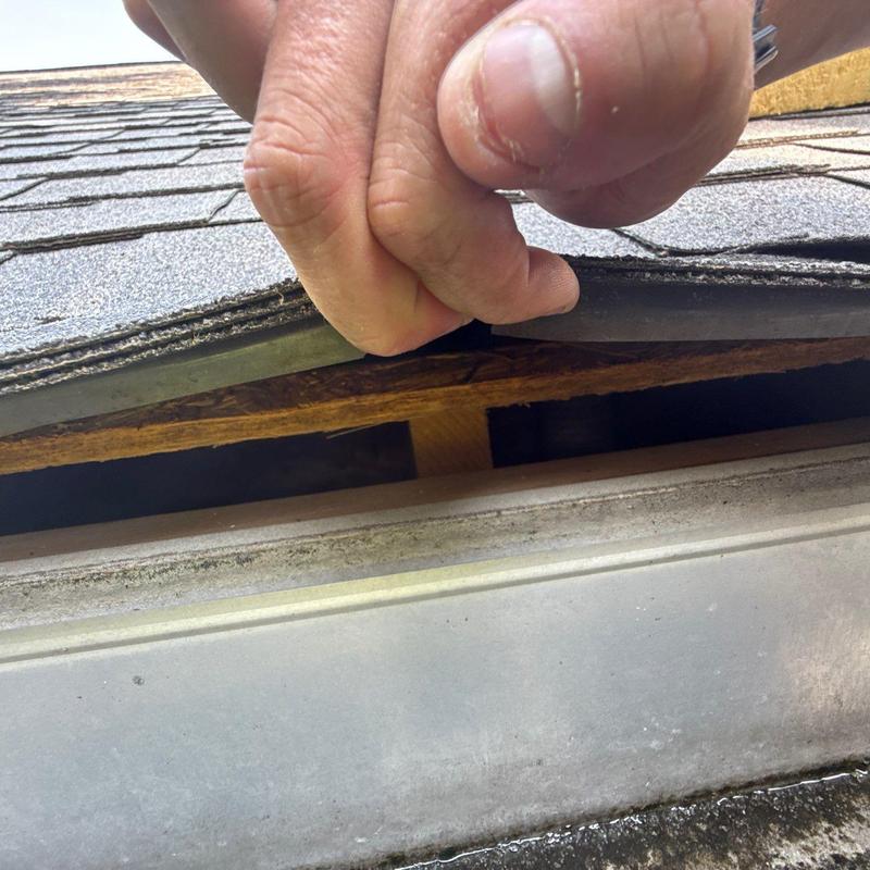 Roof shingles lifted for hail damage inspection