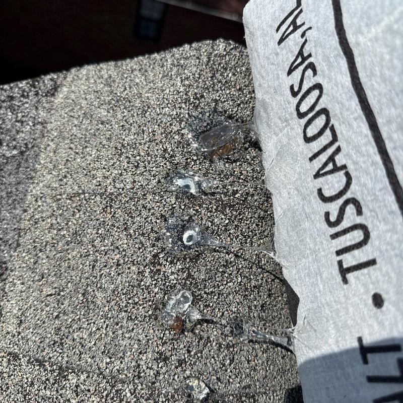 Asphalt shingles with tar spots near flashing underlayment