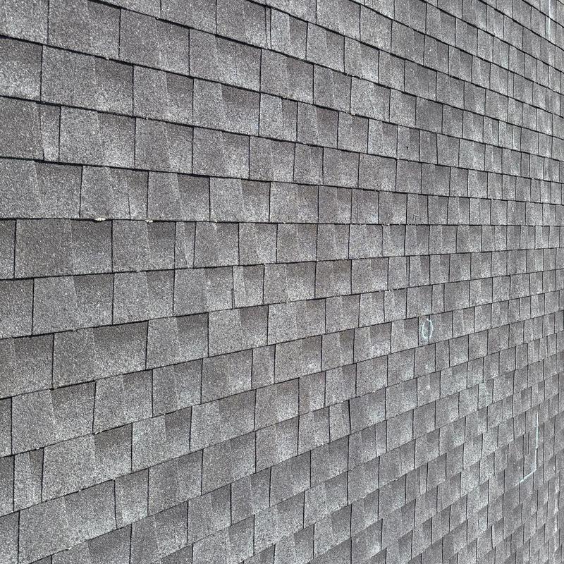 Architectural shingles with hail damage and wear