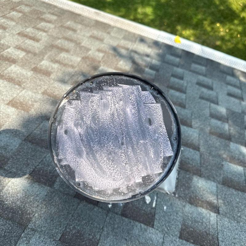 Roof vent cap with condensation on shingles