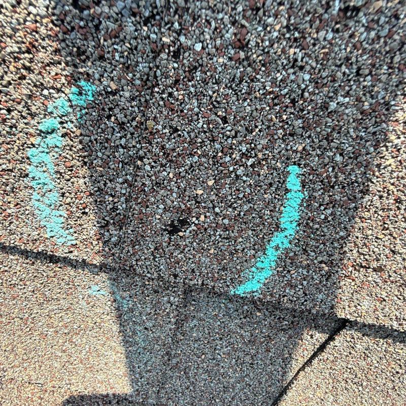 Asphalt roof shingles with hail damage markings