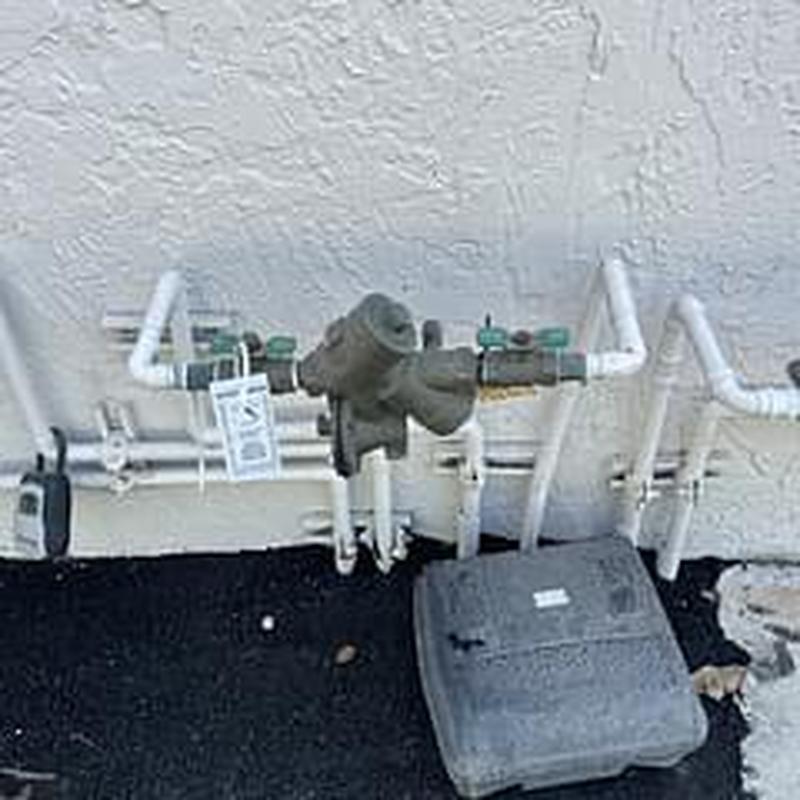 Backflow prevention device with attached piping and valves