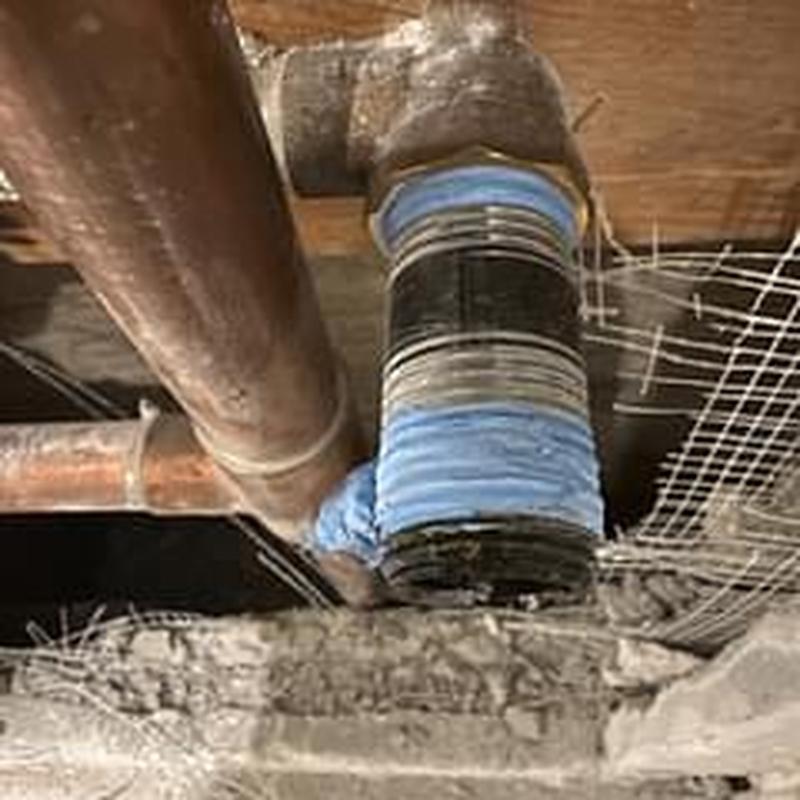 Shower drain pipe with seal tape in ceiling space