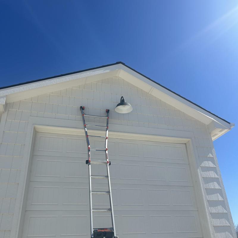 Exterior light fixture mounted above garage door with ladder Exterior light fixture mounted above garage door with ladder