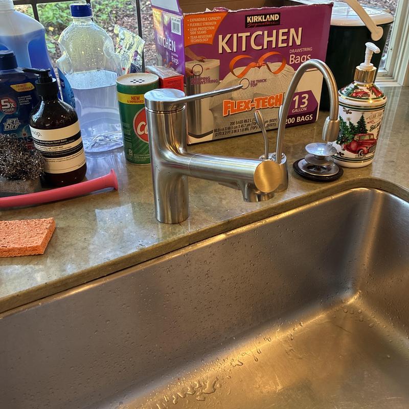 Kitchen sink faucet and drain assembly on countertop