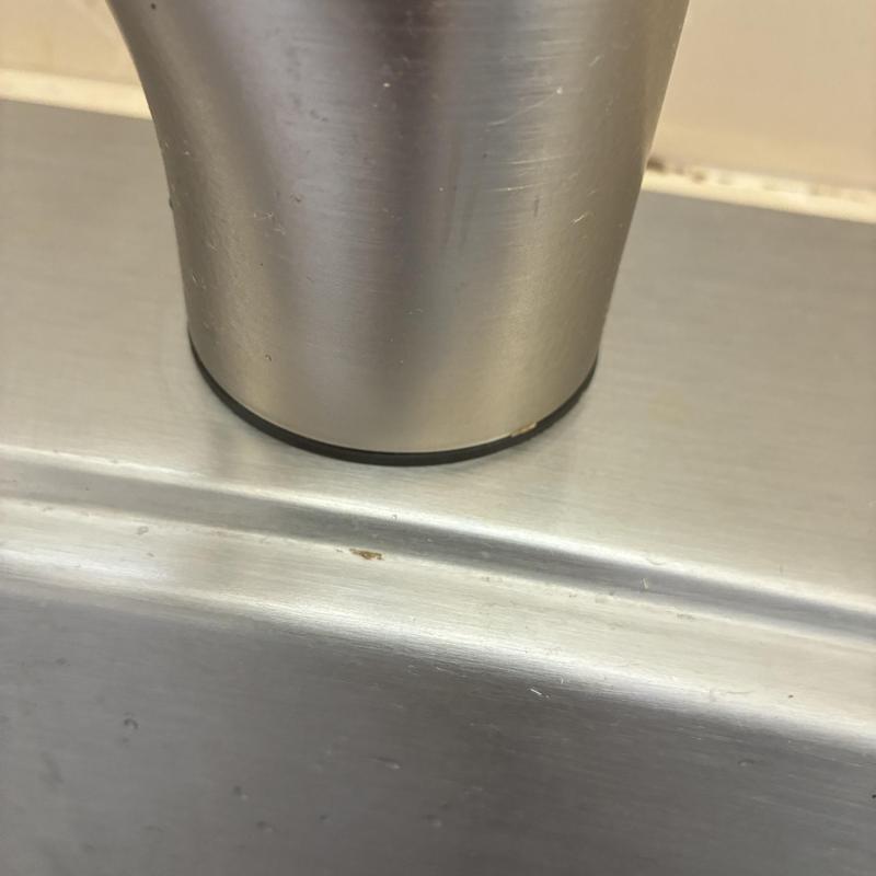 Moen kitchen faucet base and sink close-up detail