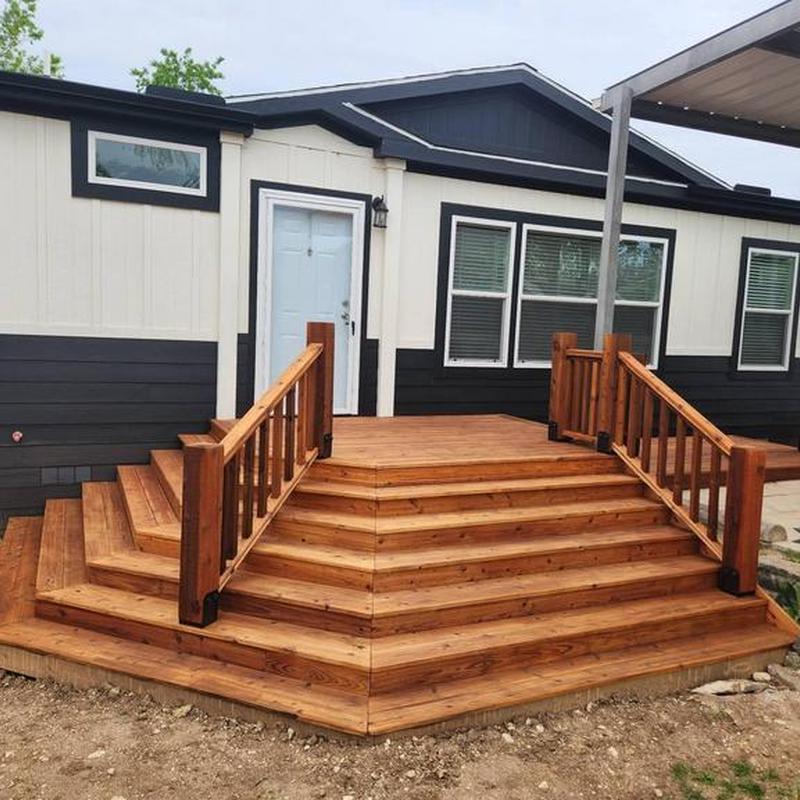 Wooden front porch with stairs and railings