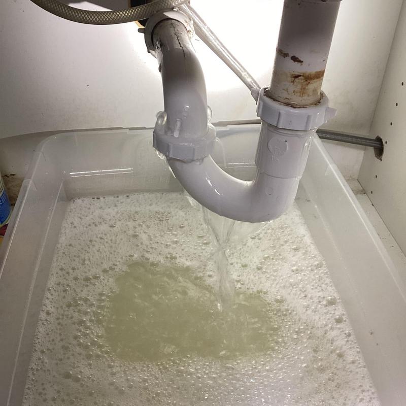 Kitchen sink P-trap leaking water into container
